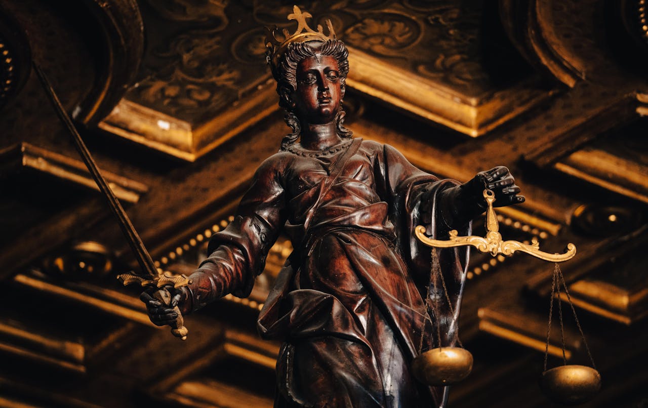 creative Detailed statue of Lady Justice holding scales and sword indoors with rich textures.